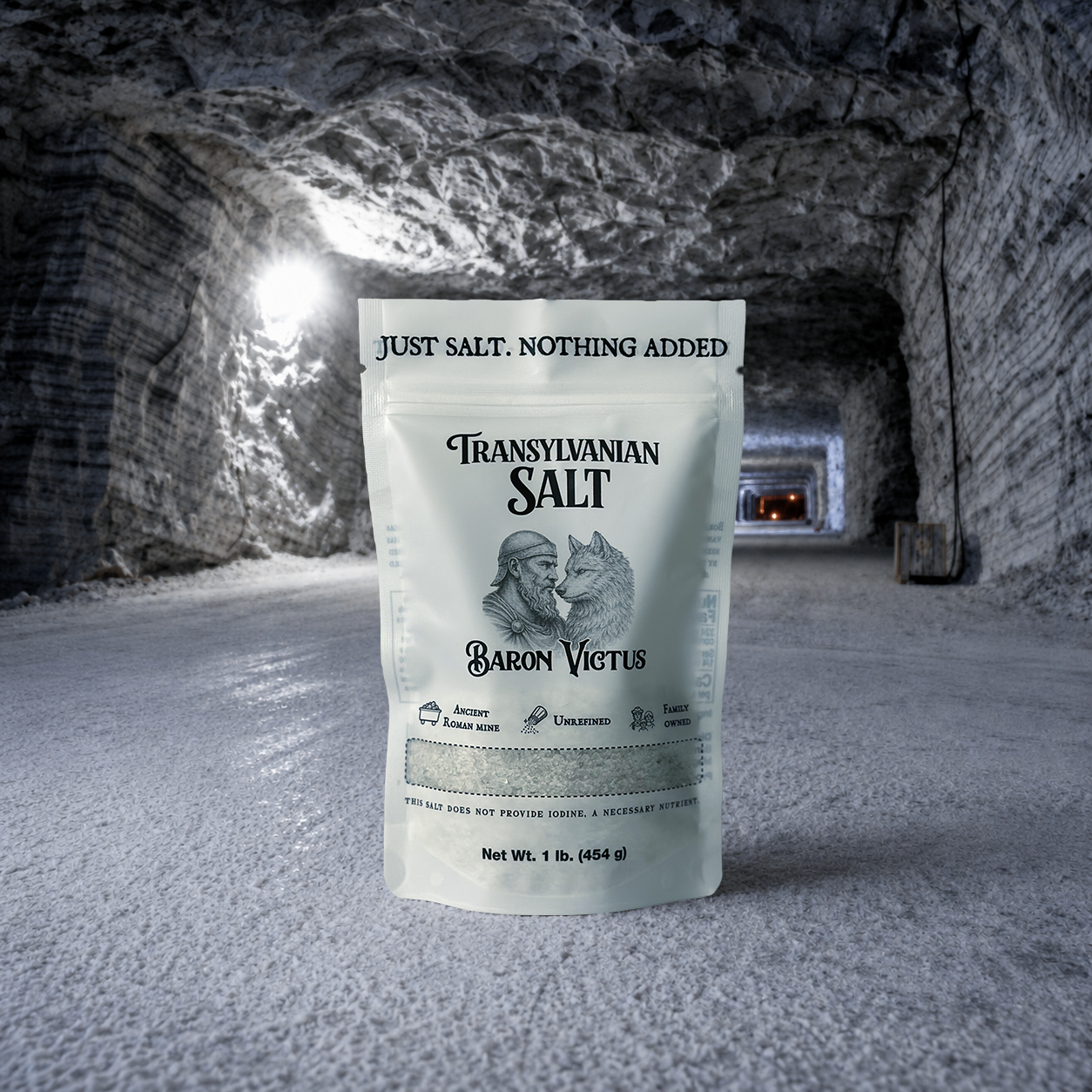 A white pouch of Baron Victus Transylvanian Salt standing on the floor of a salt mine tunnel.