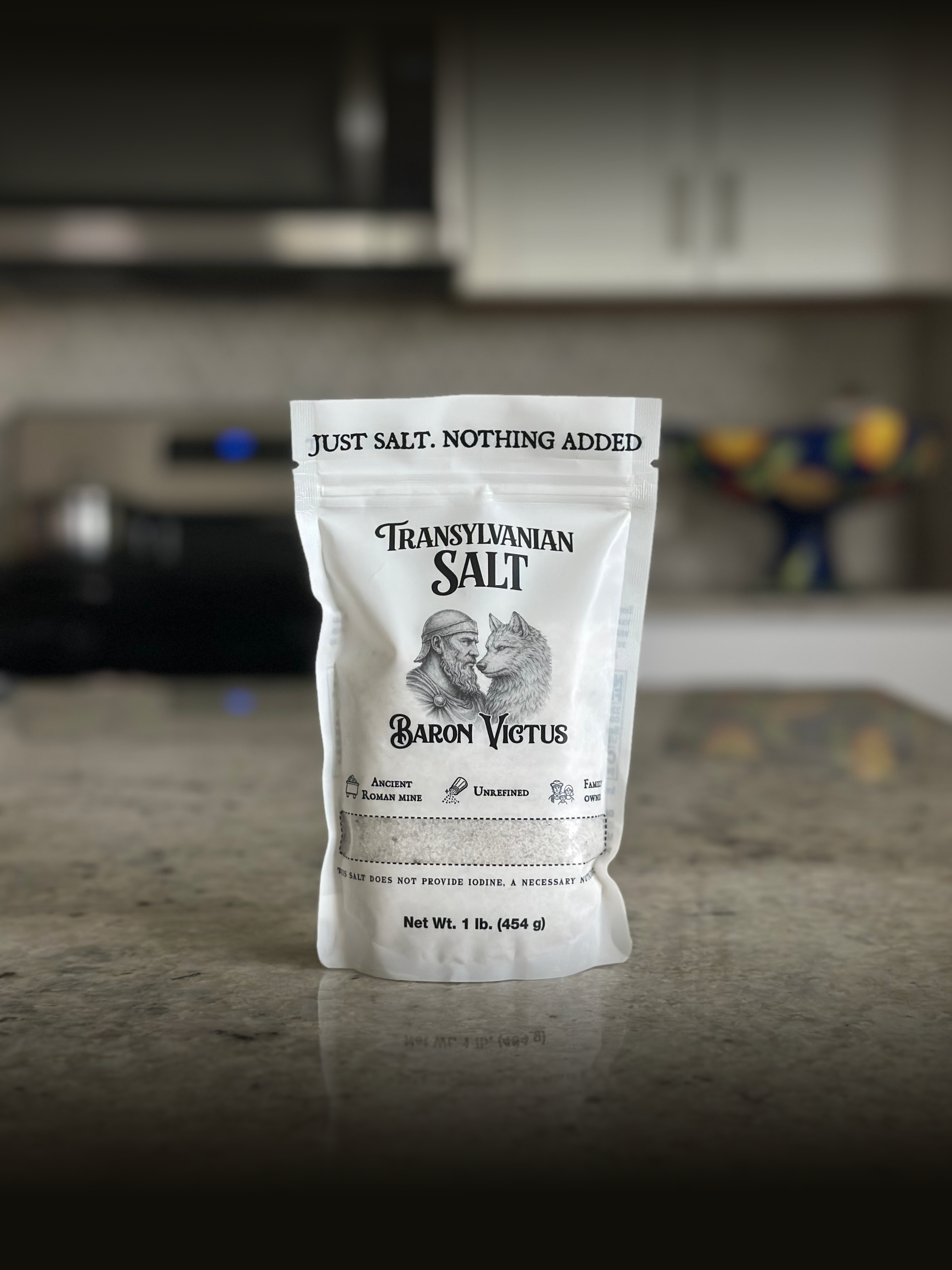 A white pouch of Baron Victus Transylvanian Salt sitting on a kitchen countertop.
