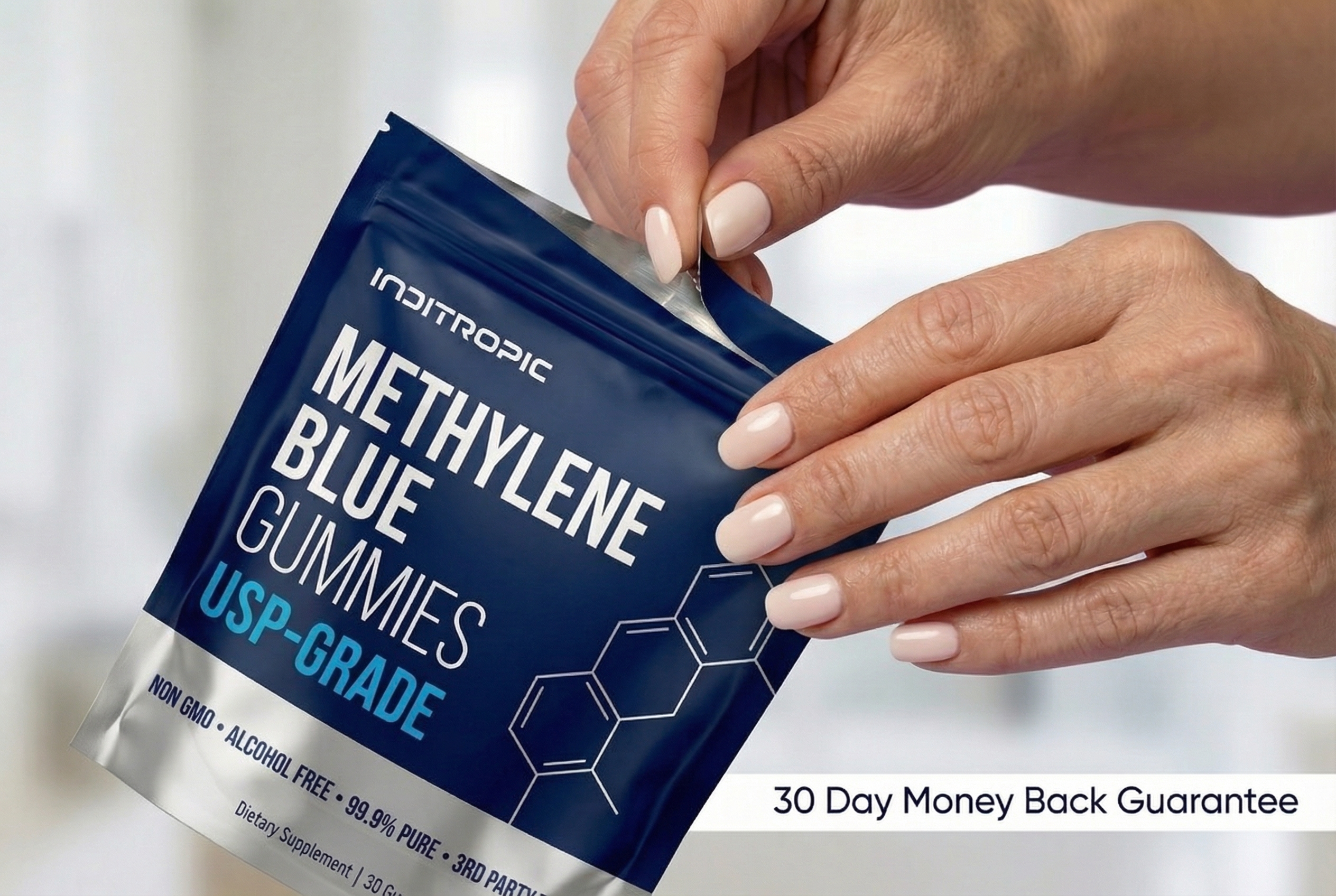 A person's hands with a nude manicure opening a blue and silver pouch of Methylene Blue Gummies.