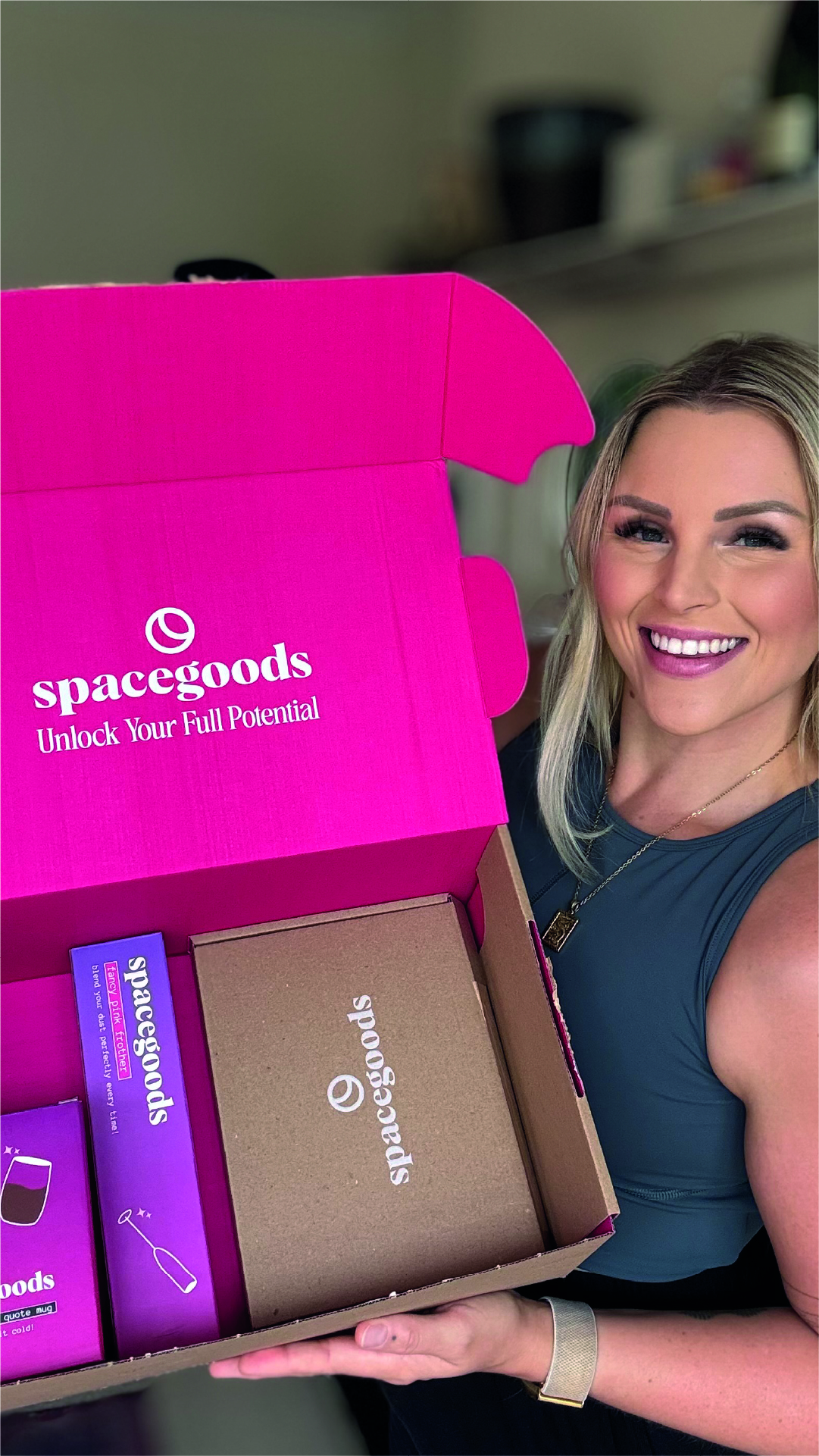 Person holding a pink Spacegoods box with products inside.