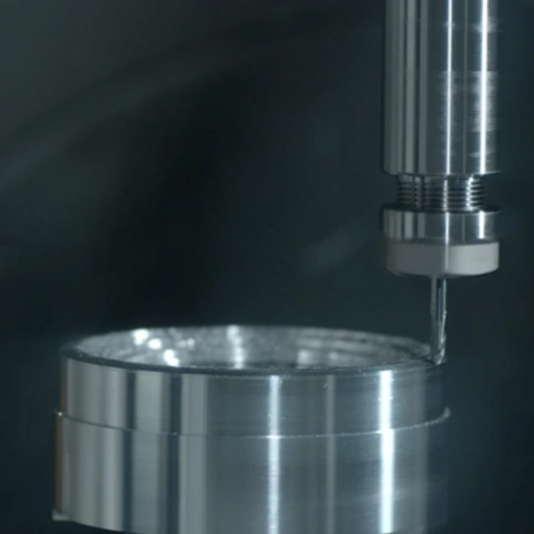 Metal drilling machine working on a cylinder piece.