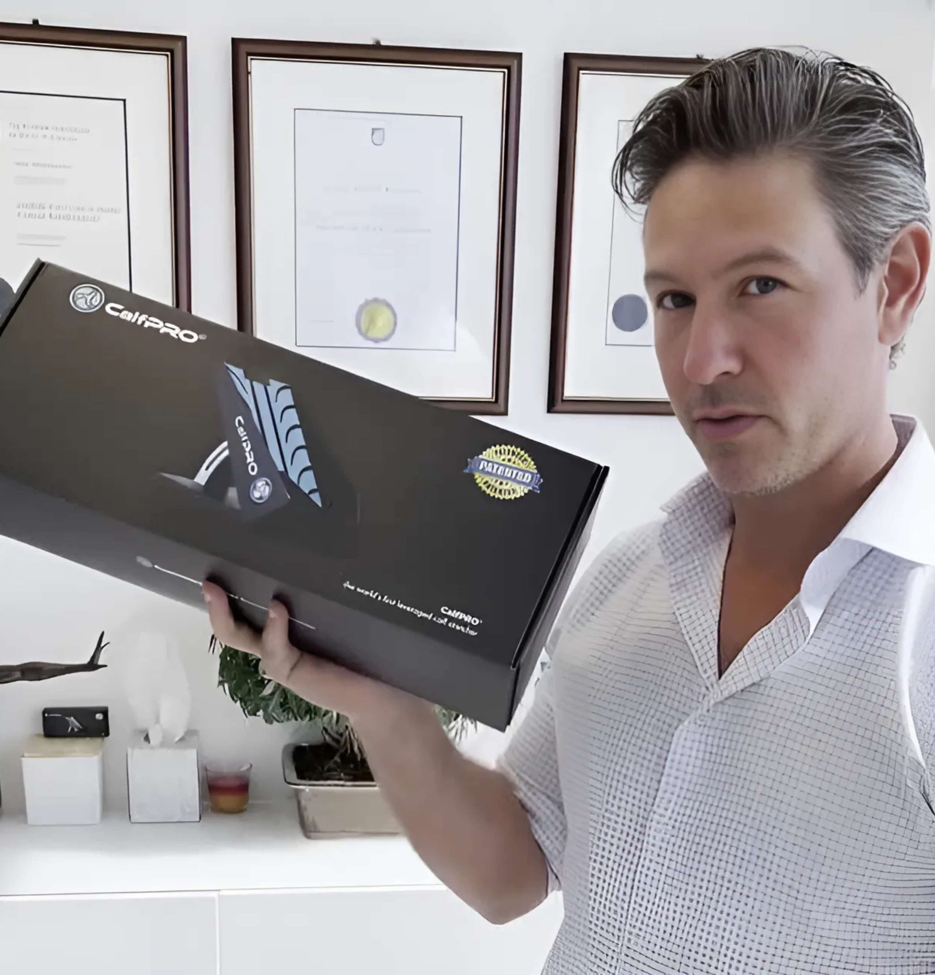 Person holding a CaliPRO product box in an office setting.