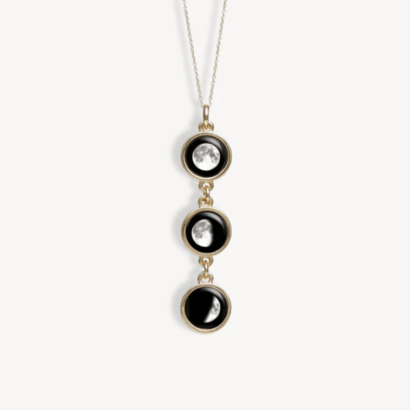 Necklace with three moon phase pendants on a chain.