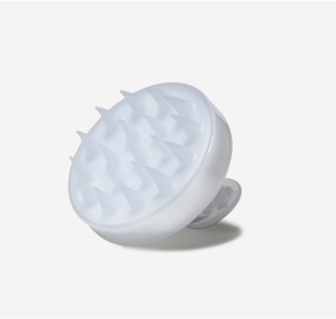 White silicone scalp massager with pointed bristles and a handle.