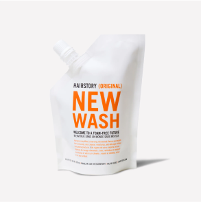 White pouch labeled 'Hairstory New Wash' against a plain background.