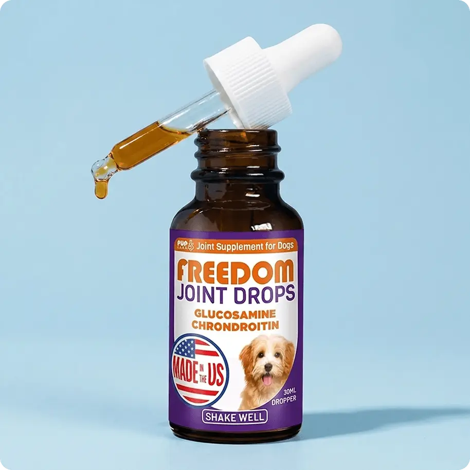 A bottle of Freedom Joint Drops for dogs, with a dropper dispensing a drop of the amber-colored liquid.