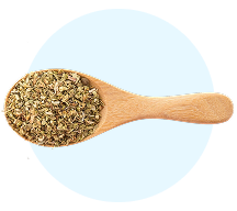Wooden spoon filled with dried herbs on a light blue background.