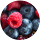 Close-up of assorted fresh berries, including raspberries and blueberries.