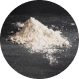 A small pile of white powder on a dark surface.