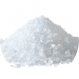 A pile of coarse white salt on a white background.