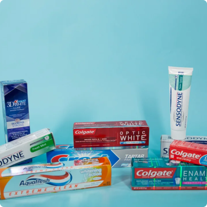 Several toothpaste brands displayed against a light blue background.