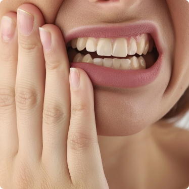 Person holding their cheek, appearing to have a toothache.