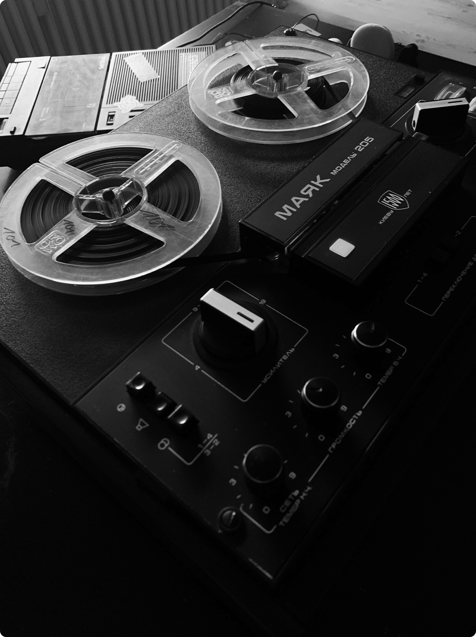 Black and white image of a vintage reel-to-reel tape recorder.