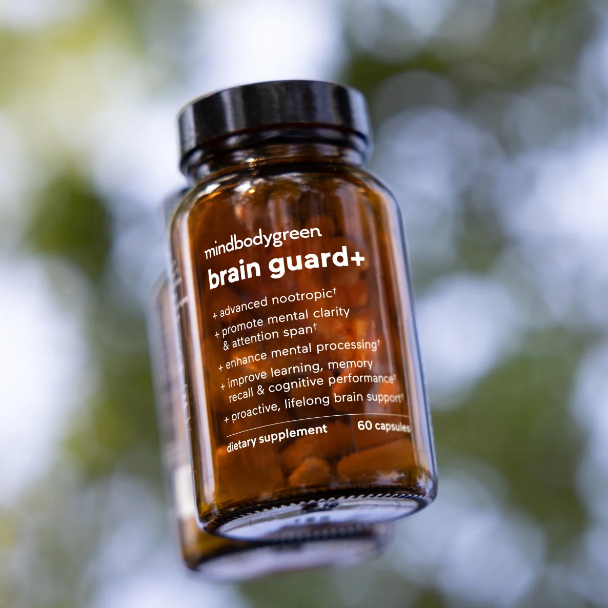 Brown bottle of brain guard+ capsules on white blocks, labeled 'best seller.'