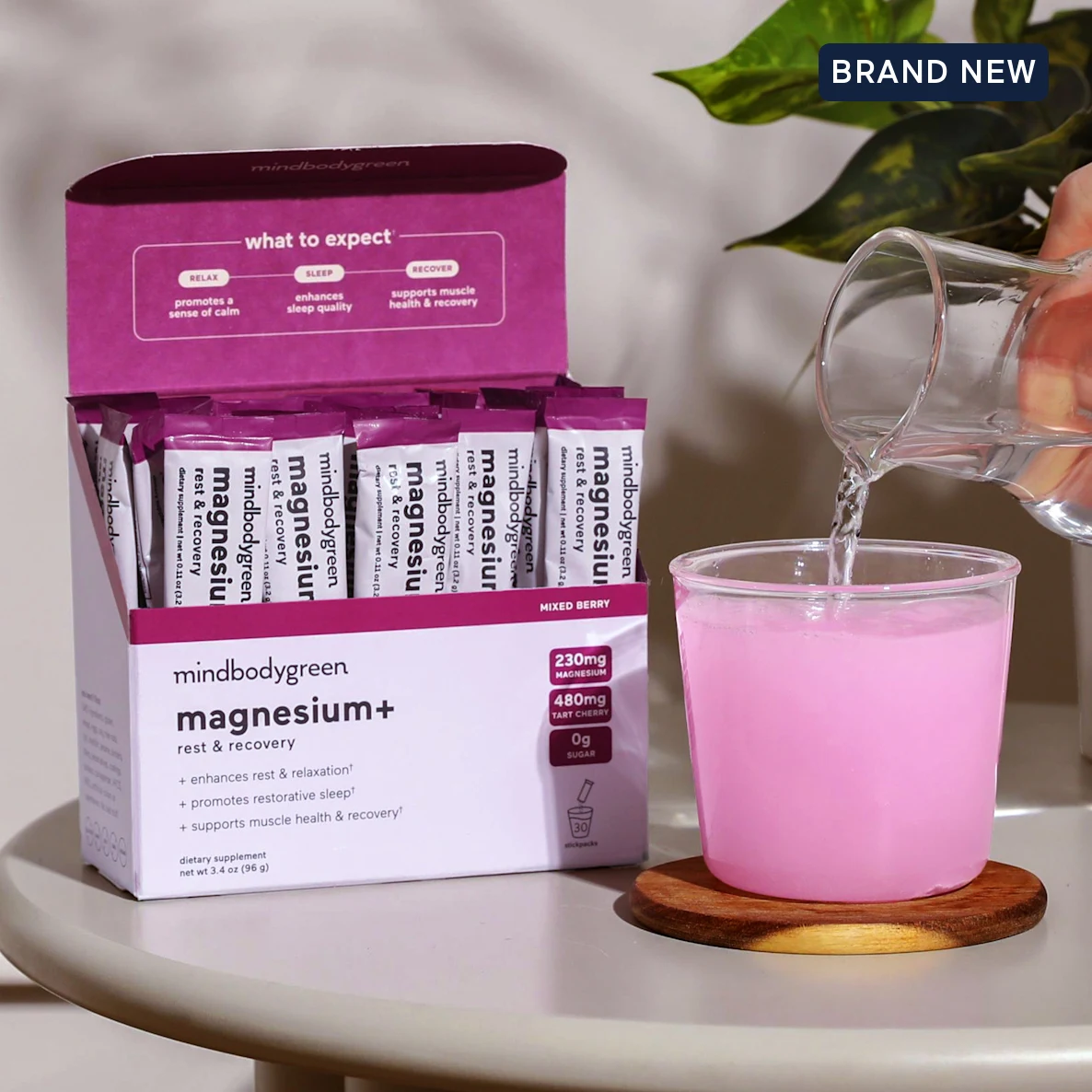 Box of magnesium supplement with water being poured into a pink drink.