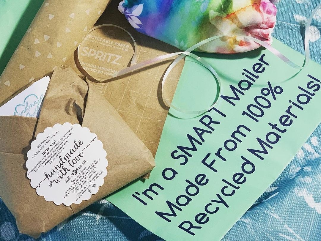 Green recycled poly mailer with brown envelope and handmade product