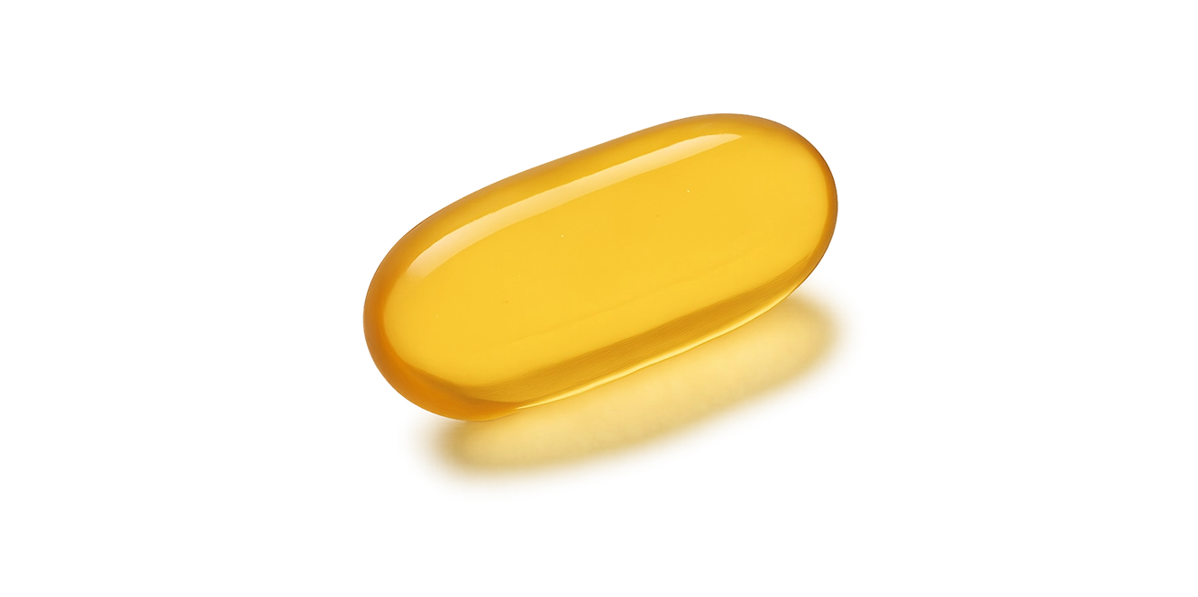 Yellow gel capsule on a white background.