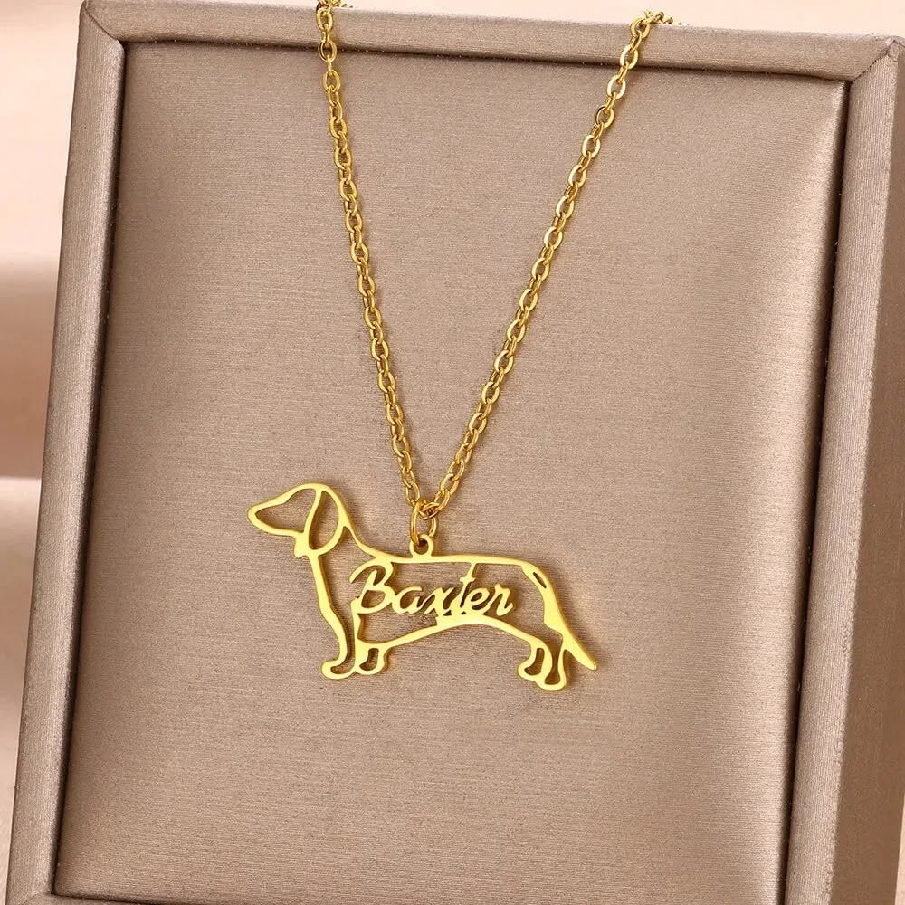 Gold necklace with a dachshund pendant and the name 'Baxter' inside.
