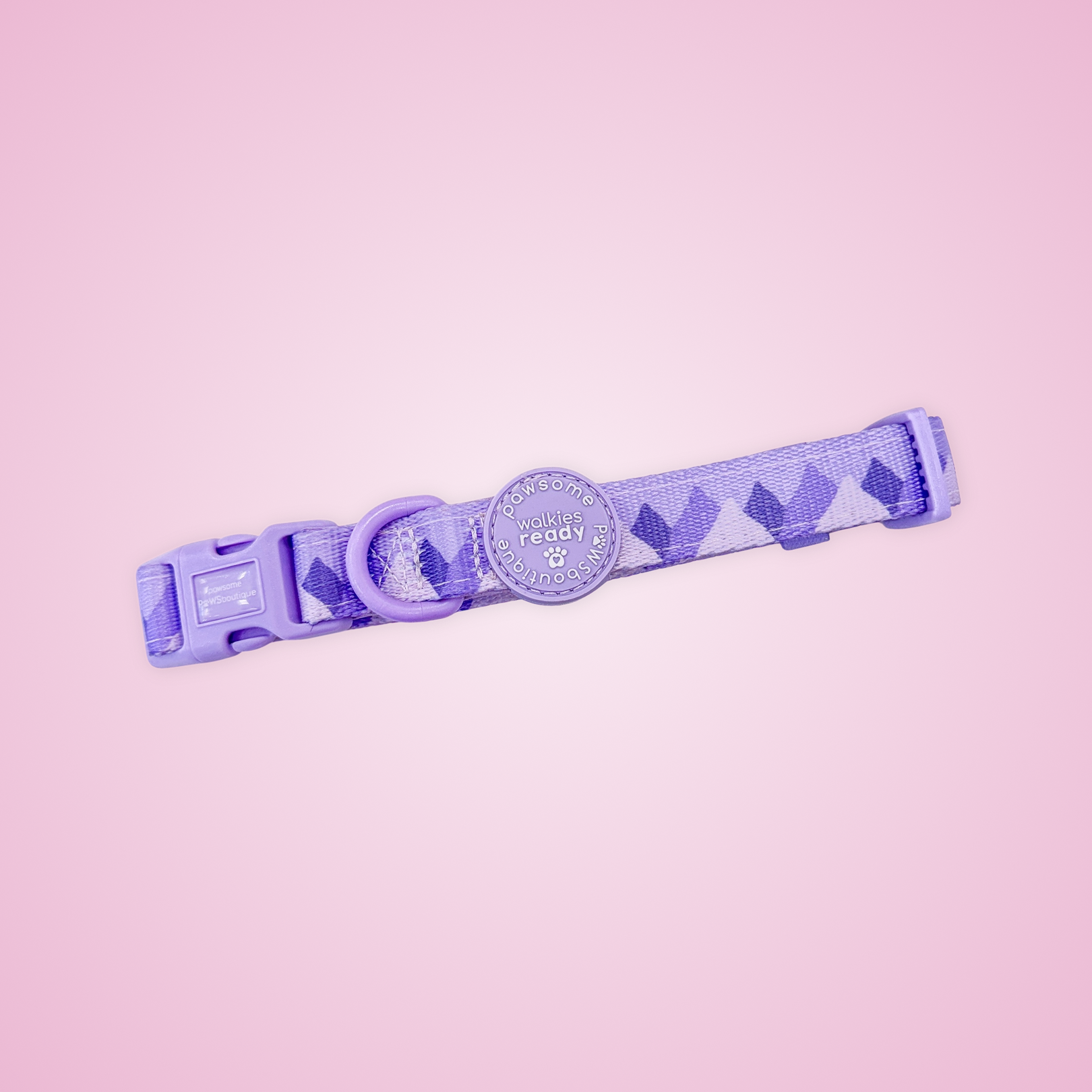 A purple dog collar with a geometric diamond pattern, shown against a solid pink background.