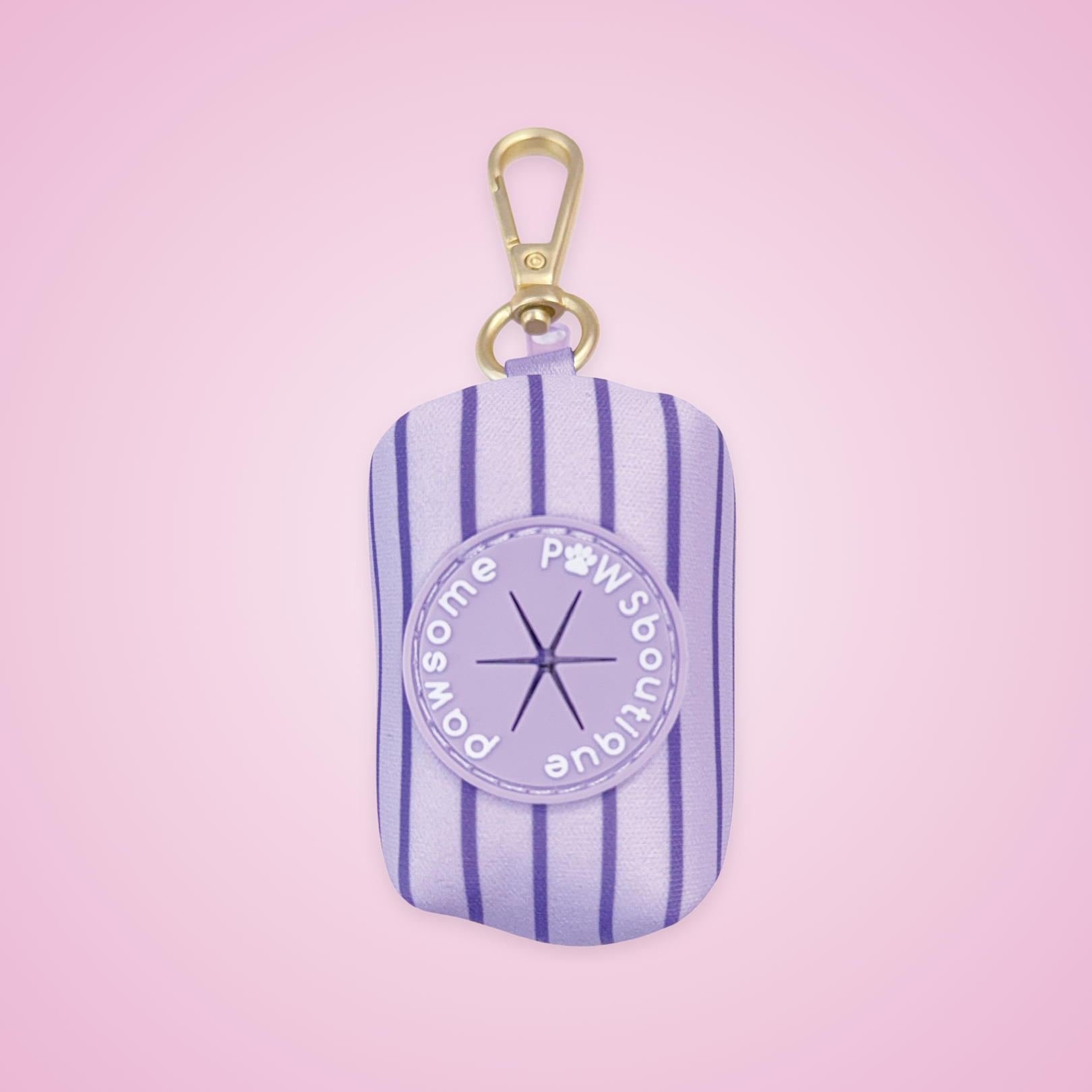 A lavender and purple striped dog poop bag dispenser with a gold clip, on a pink background.