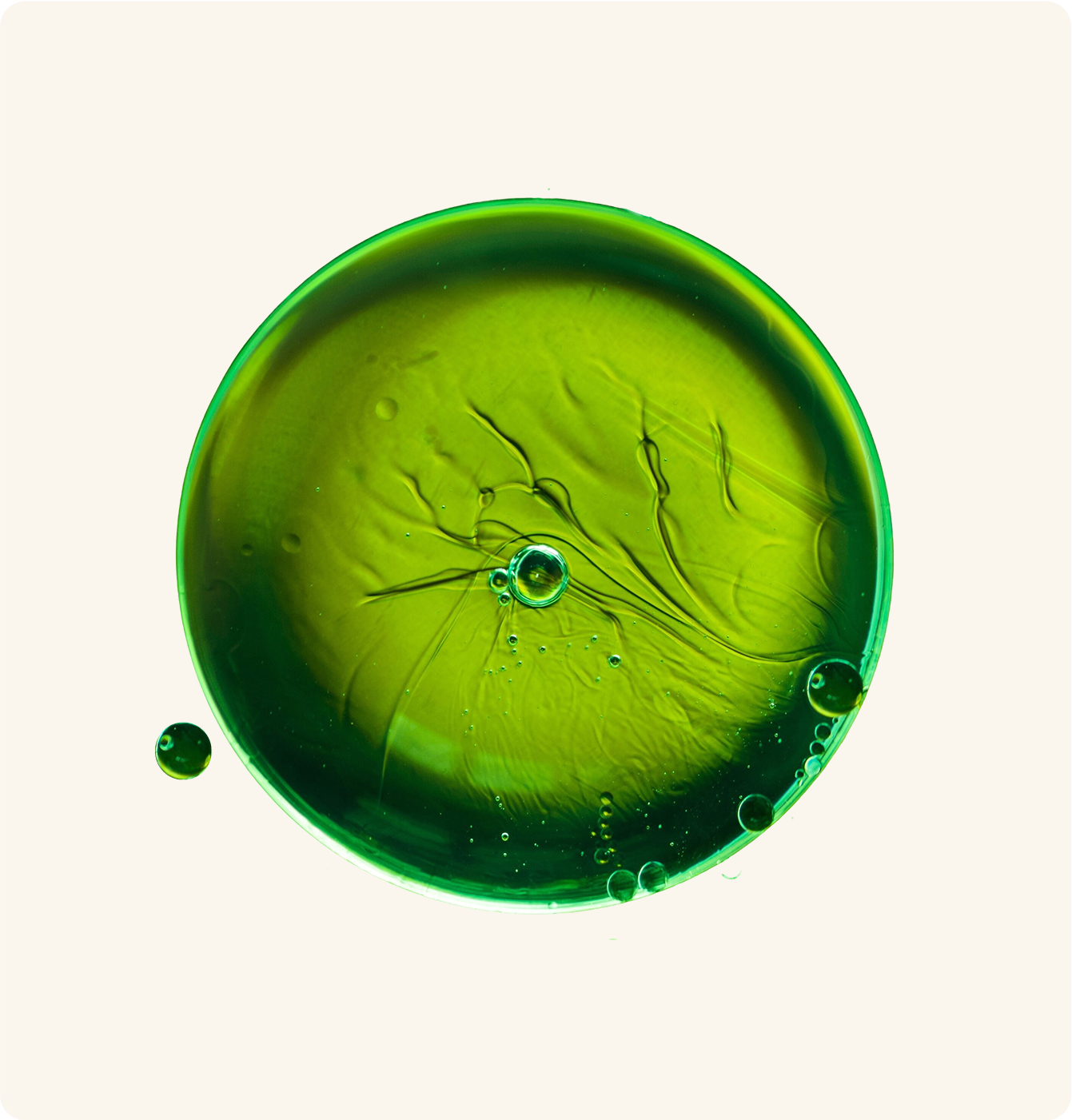 Green liquid droplets with bubbles on a white background.
