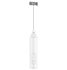 A white handheld electric milk frother on a black background.