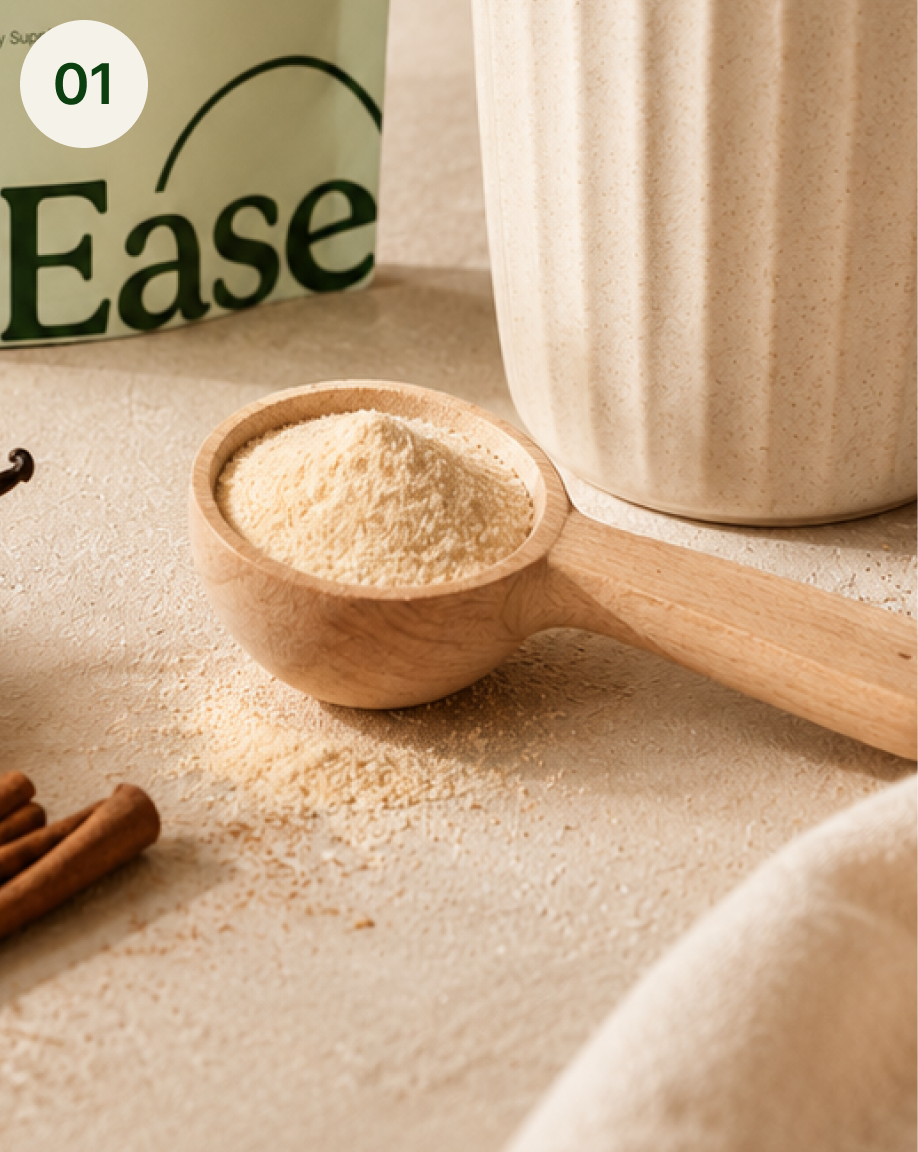 A wooden scoop of powder next to a mug, a product bag, cinnamon sticks, and a vanilla bean.