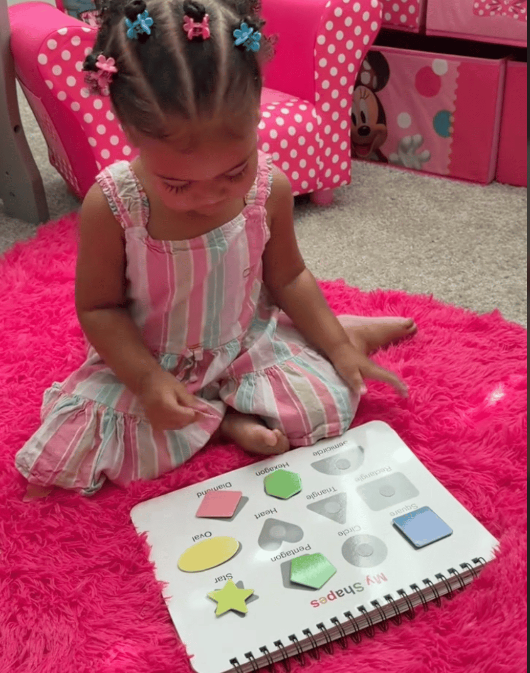 Child focused calmly on the Busy Book during a meltdown moment