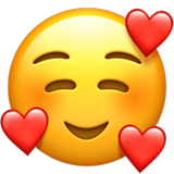 Smiling face emoji with three hearts around it.