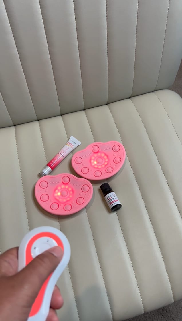 Pink LED devices, a lotion tube, and a small bottle on a beige seat.