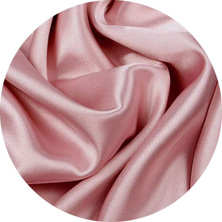 A circular close-up of draped, shiny, pink fabric.