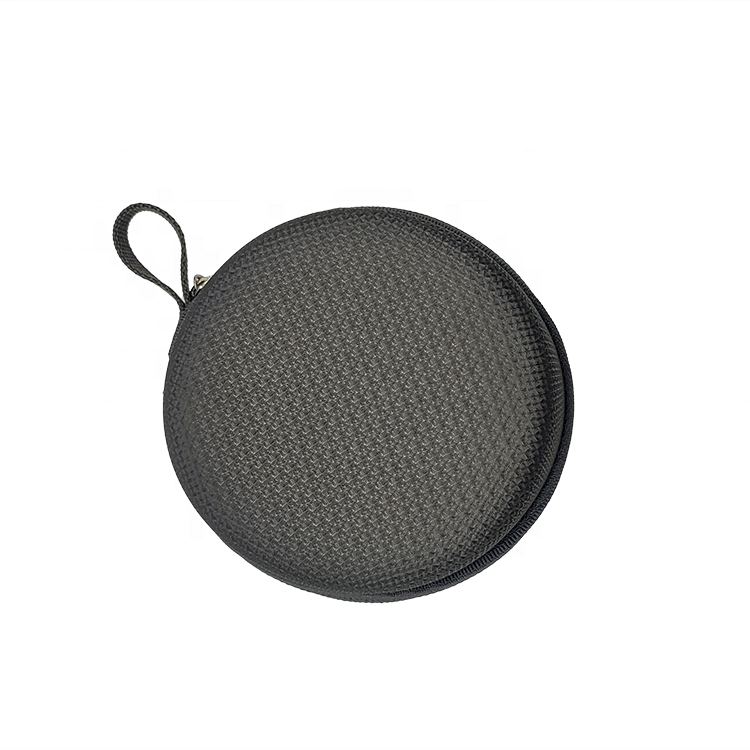 A small, round, black zippered case with a textured surface and a carrying loop.