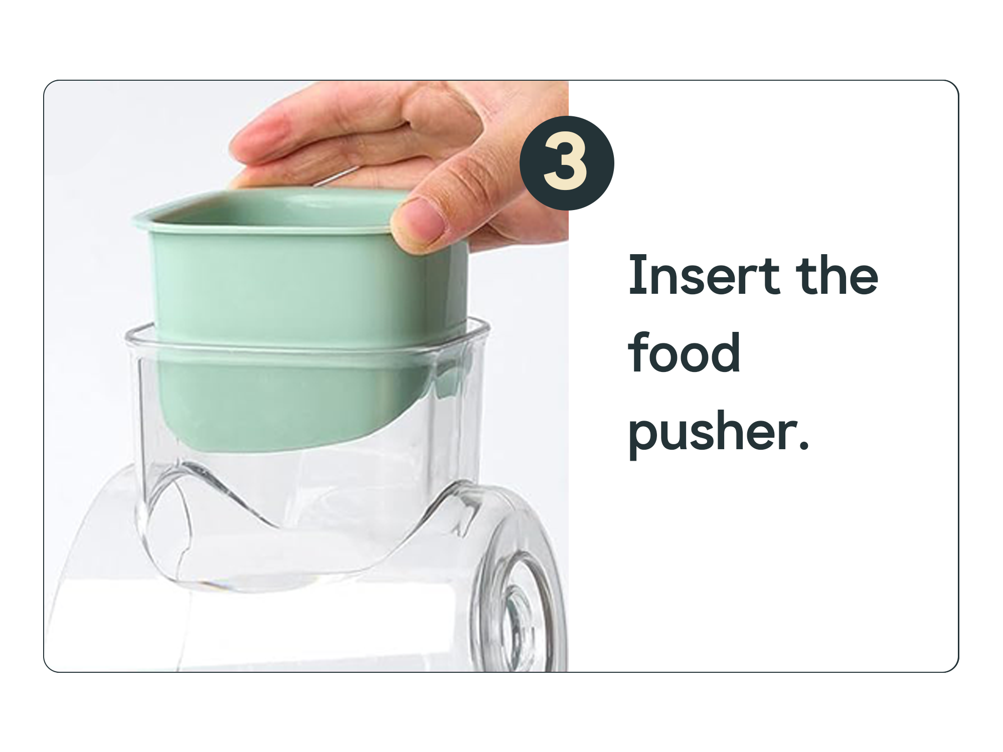Hand inserting a green food pusher into a kitchen appliance.