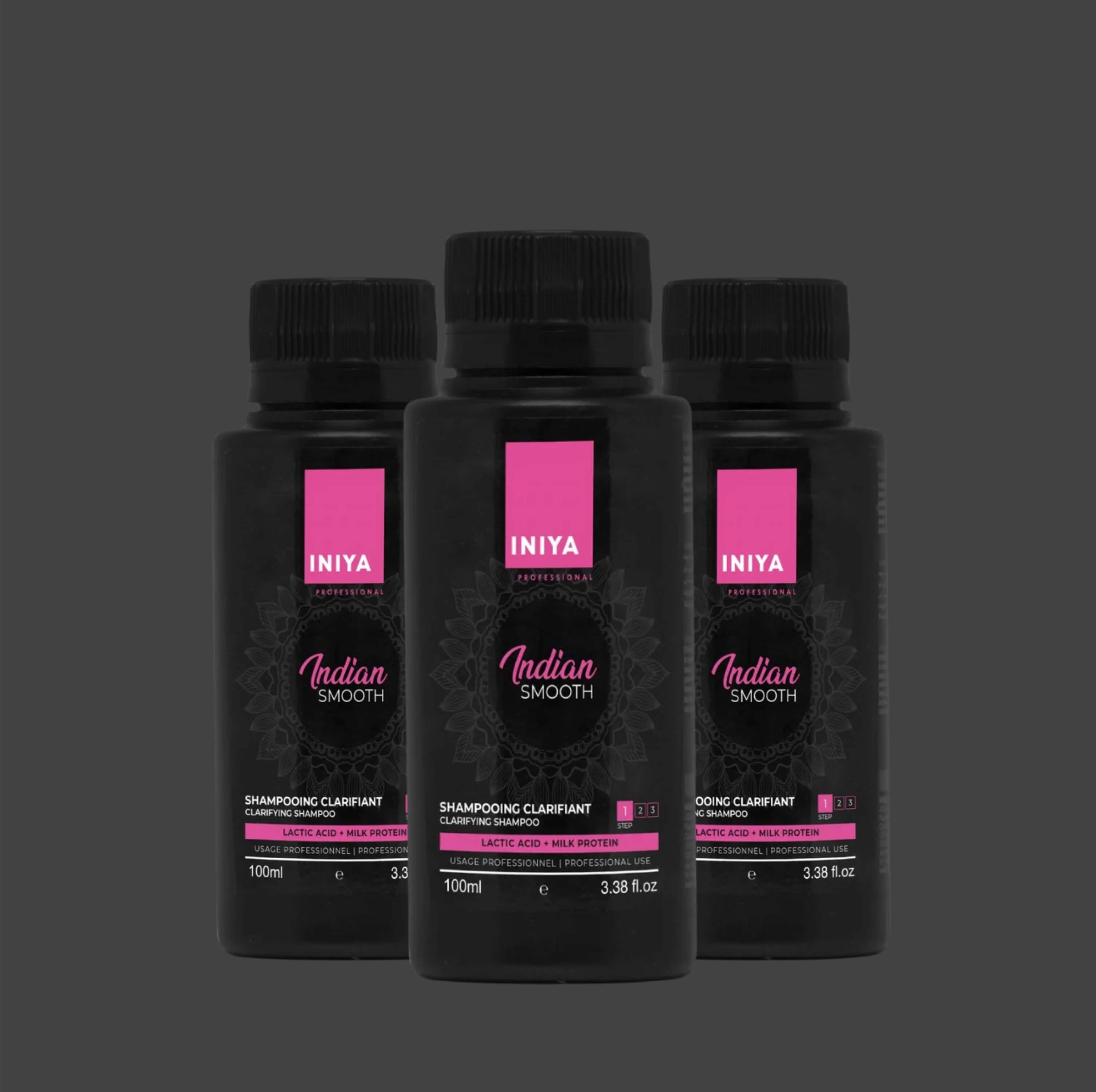 Three black shampoo bottles labeled 'Iniya Indian Smooth' on a gray background.