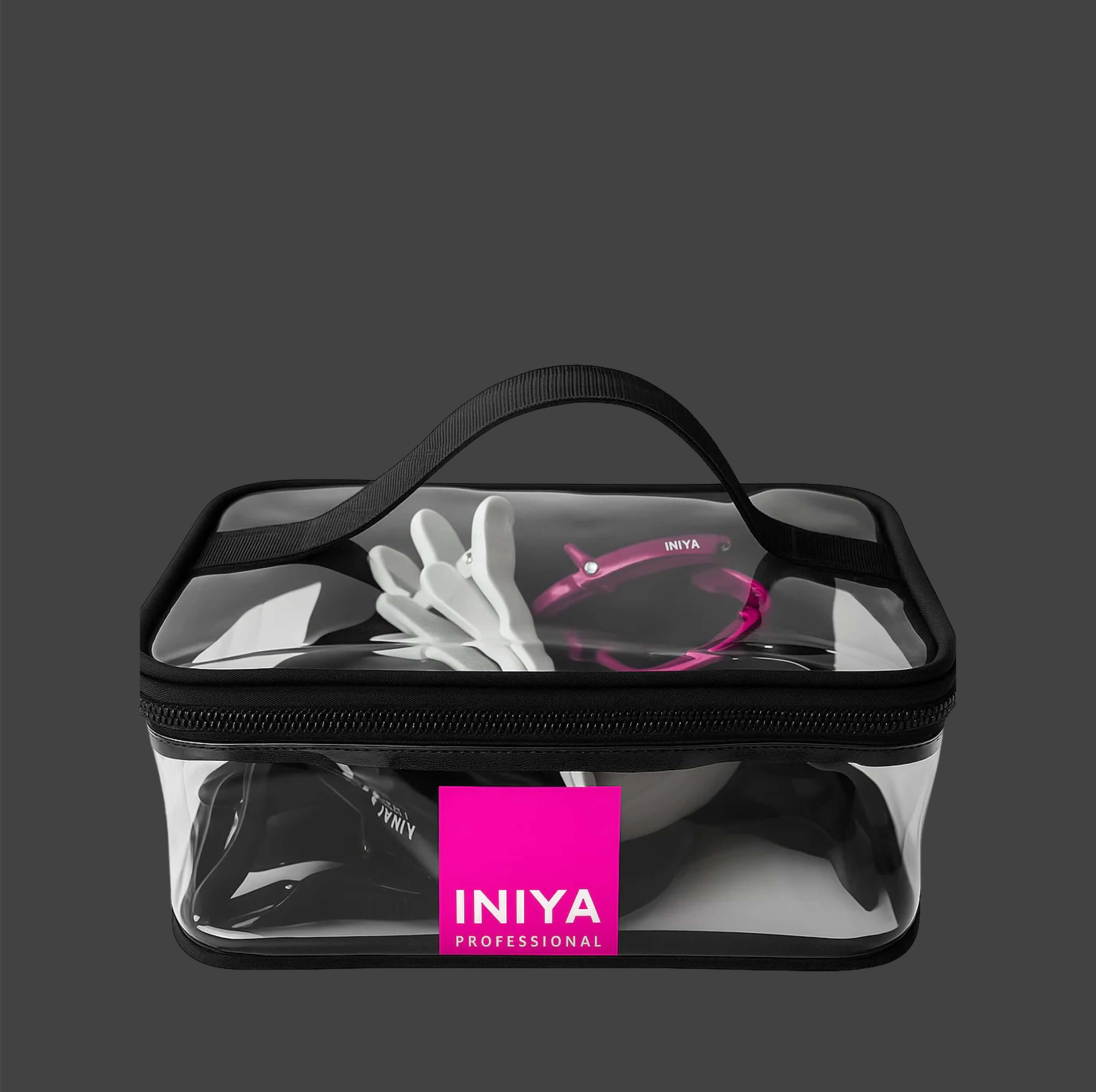 Clear cosmetic case with a handle containing beauty accessories.