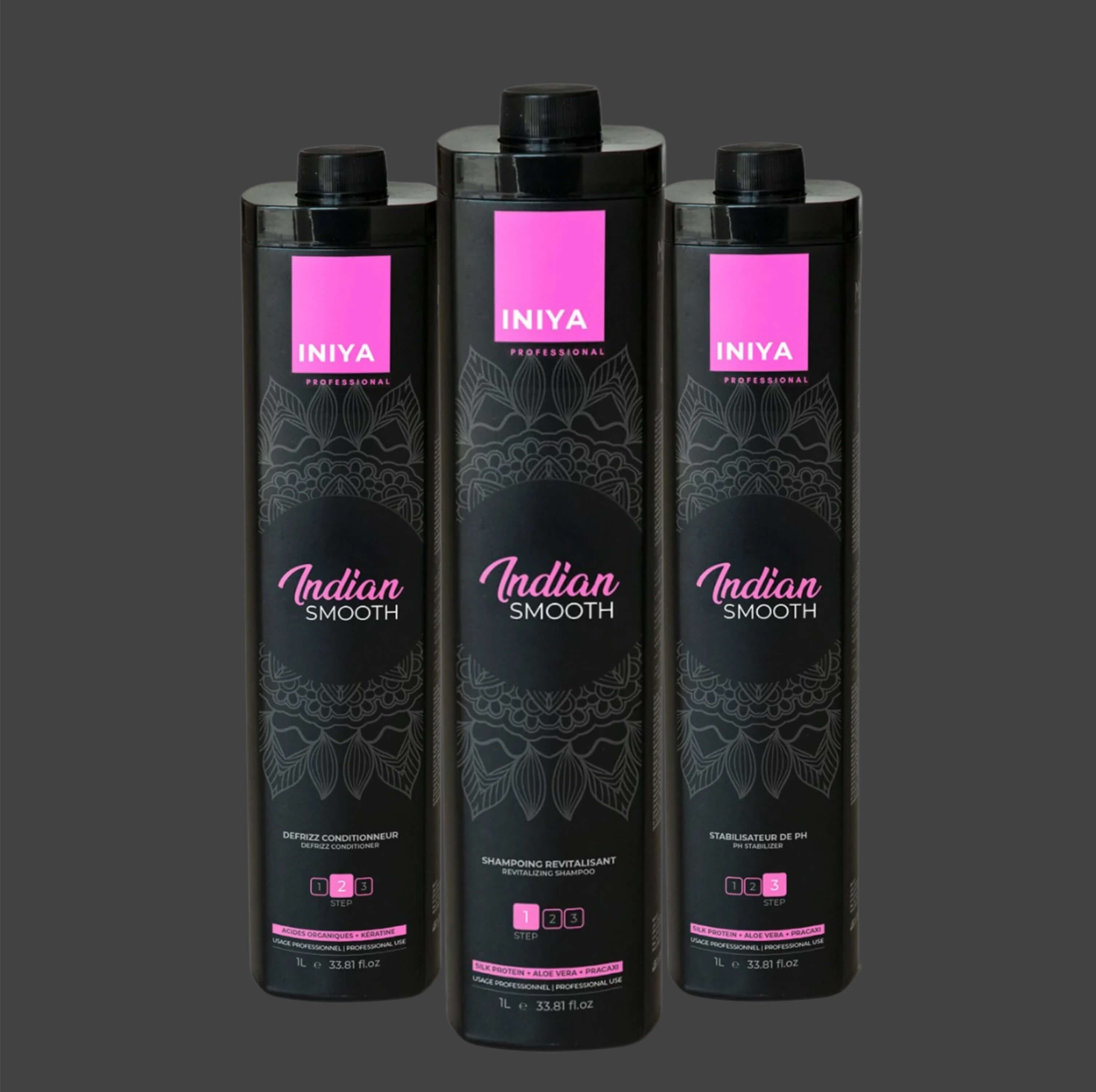Three black bottles of 'Indian Smooth' hair care products with pink labels.