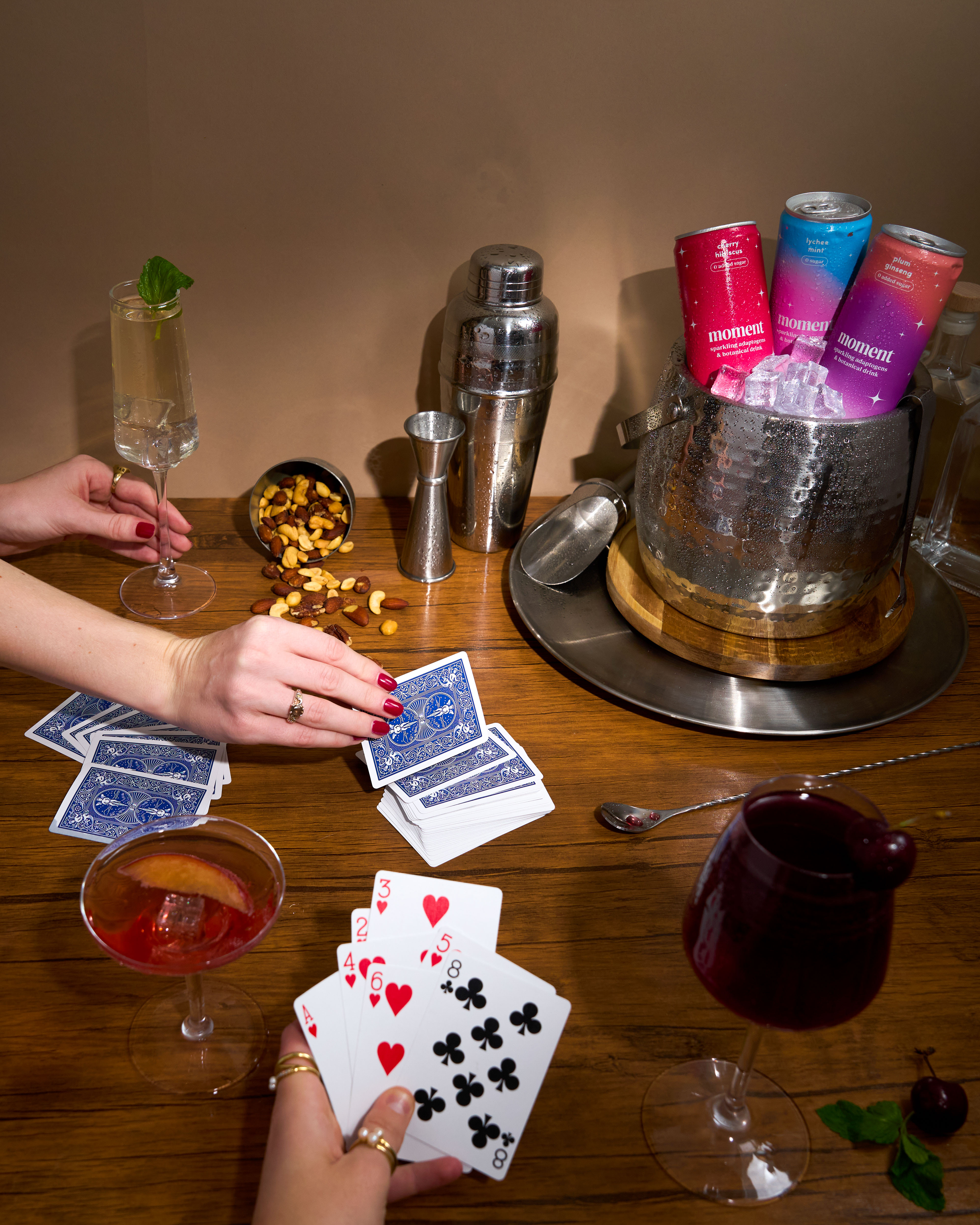 Person smiling and holding a pink can outdoors.