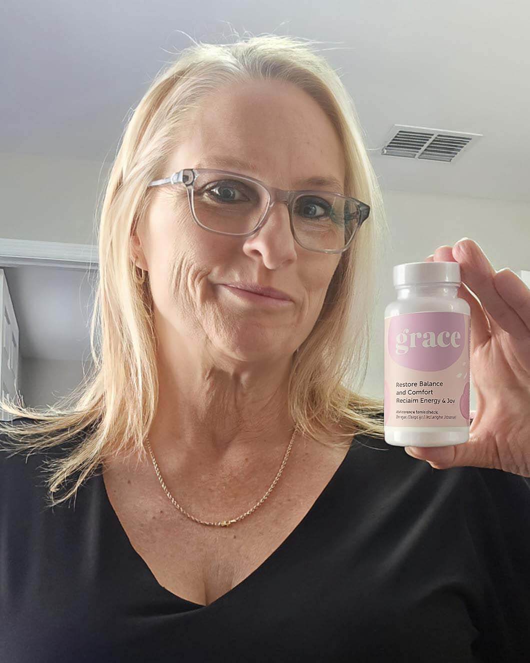 Person holding a bottle labeled 'grace' with a light pink label.