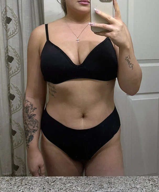 Person in black underwear taking a mirror selfie.
