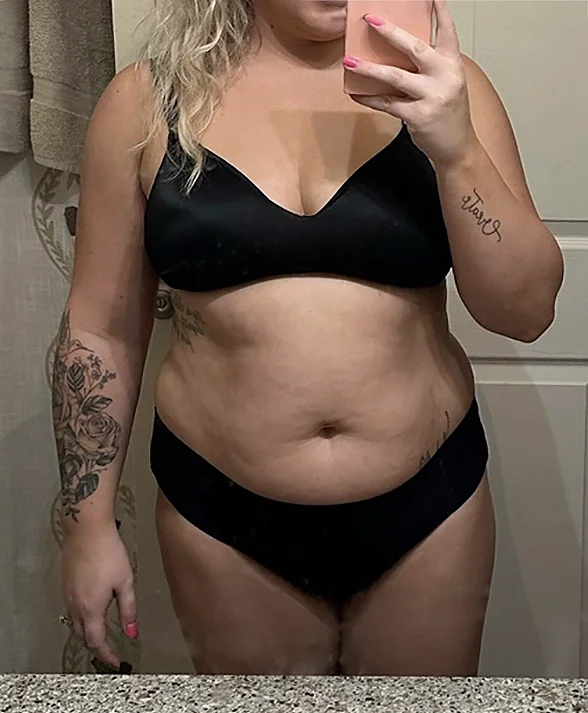 Person in black underwear taking a mirror selfie.