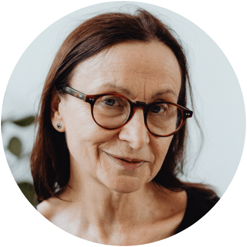 Person with glasses and dark hair, smiling slightly.