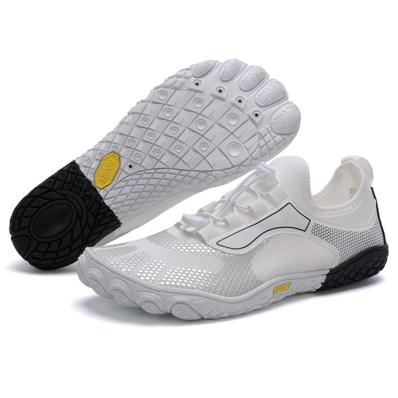 White athletic shoes with textured soles, one shoe upright and one showing the sole.