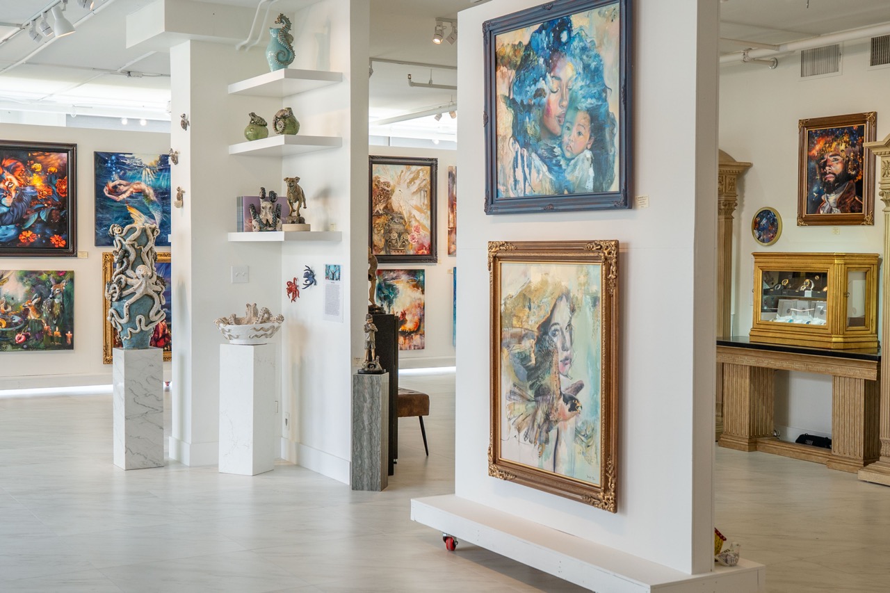 Art gallery with colorful paintings and sculptures on display.
