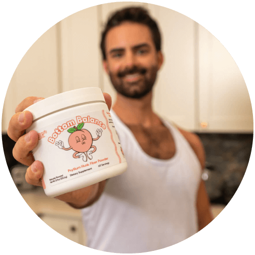 Person holding a container labeled 'Bottom Balance' in a kitchen.