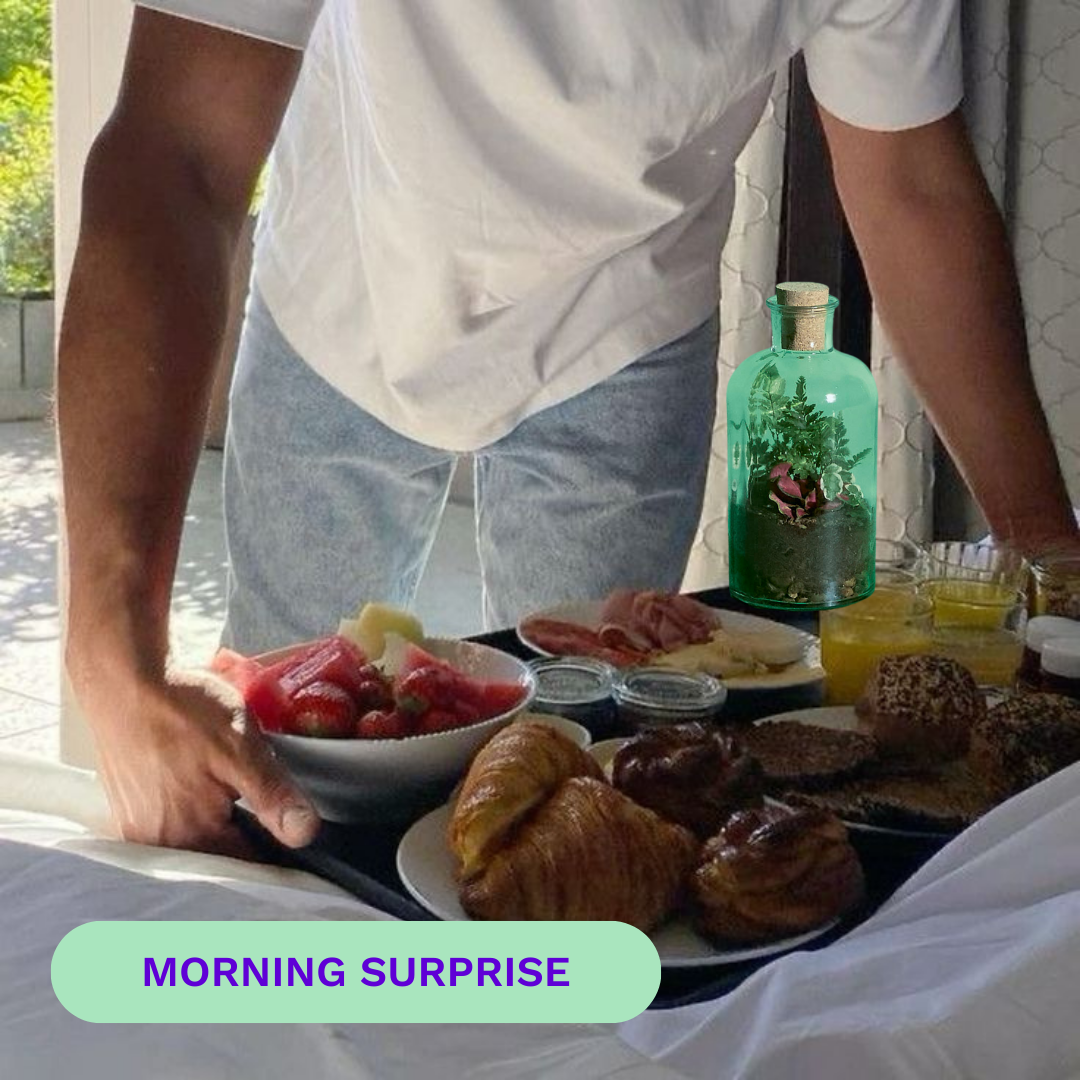 Person serving breakfast on a tray with pastries, fruit, and drinks.