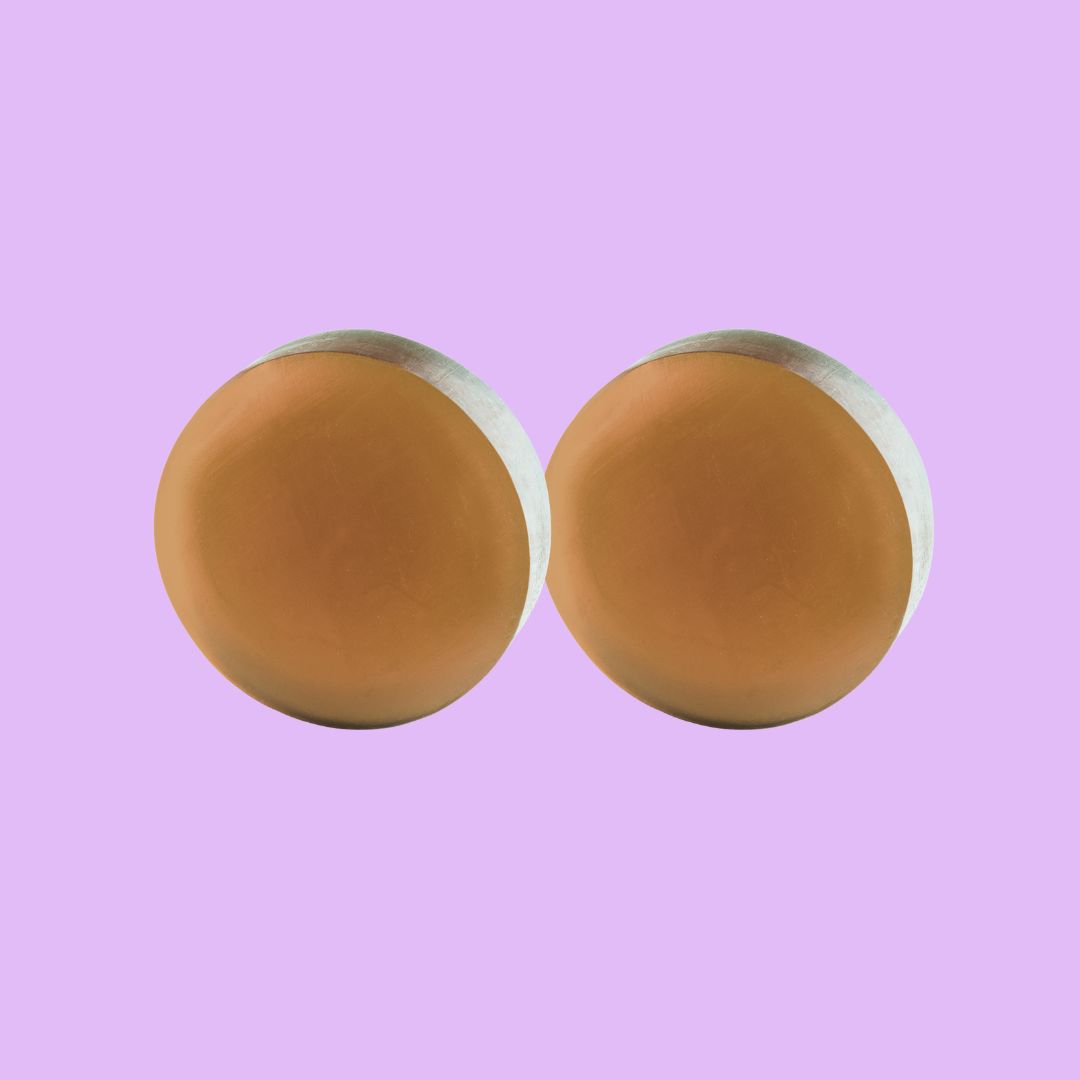 Two round, brown objects on a purple background.