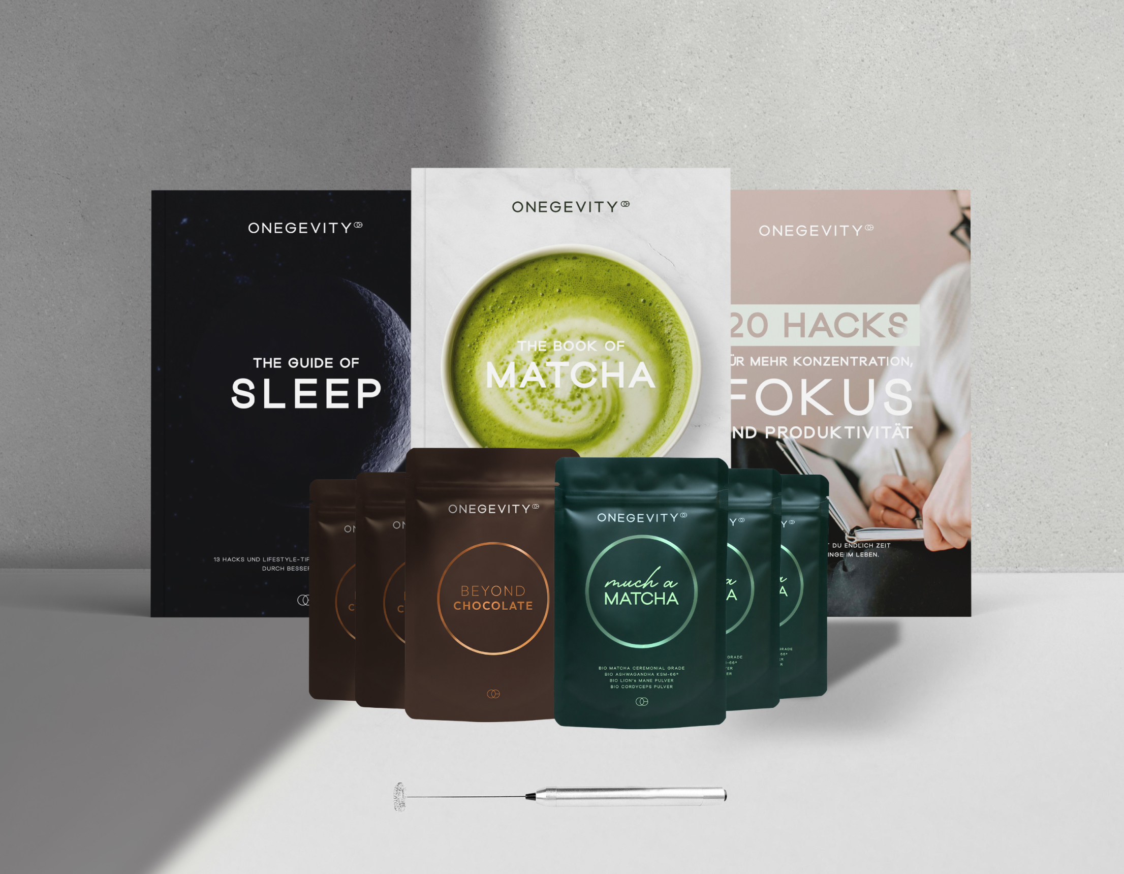 Display of Ongevity products including books and packaged goods on a light background.