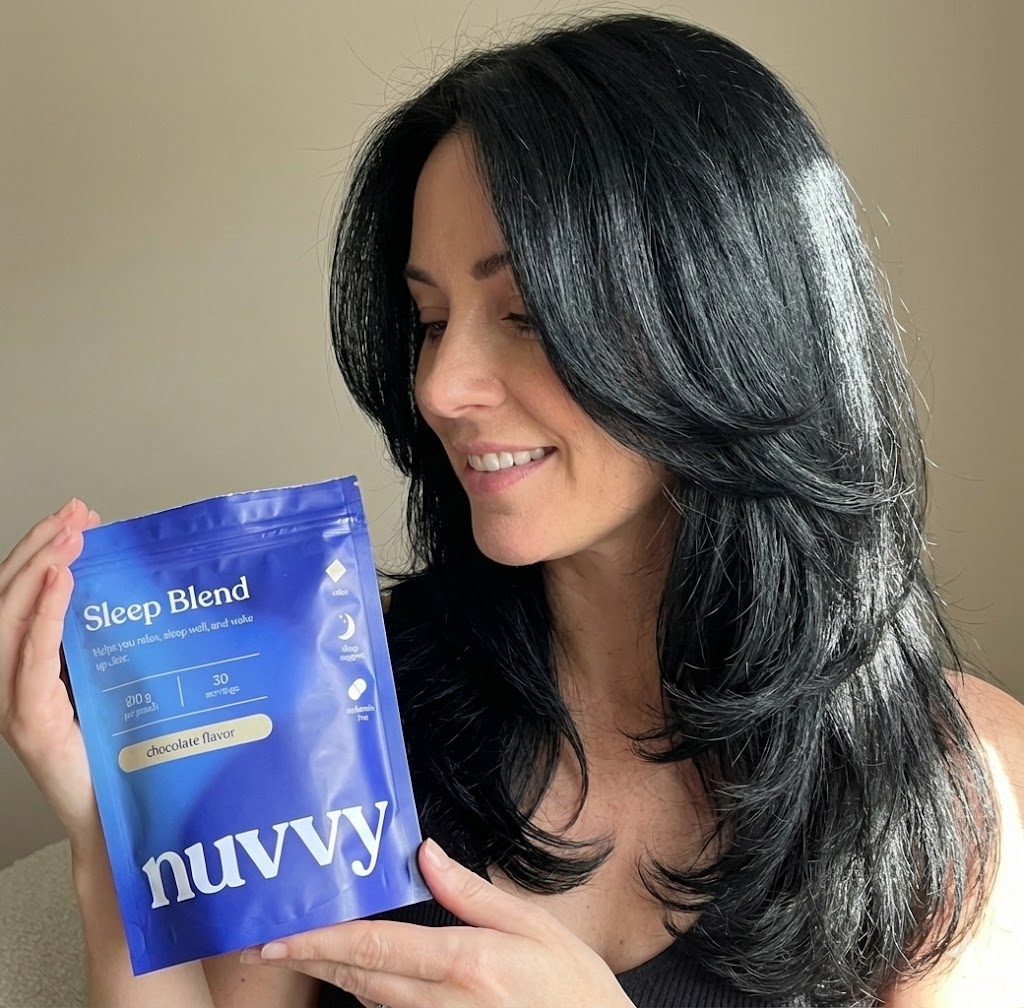 Person holding a blue package of Nuvvy Sleep Blend.