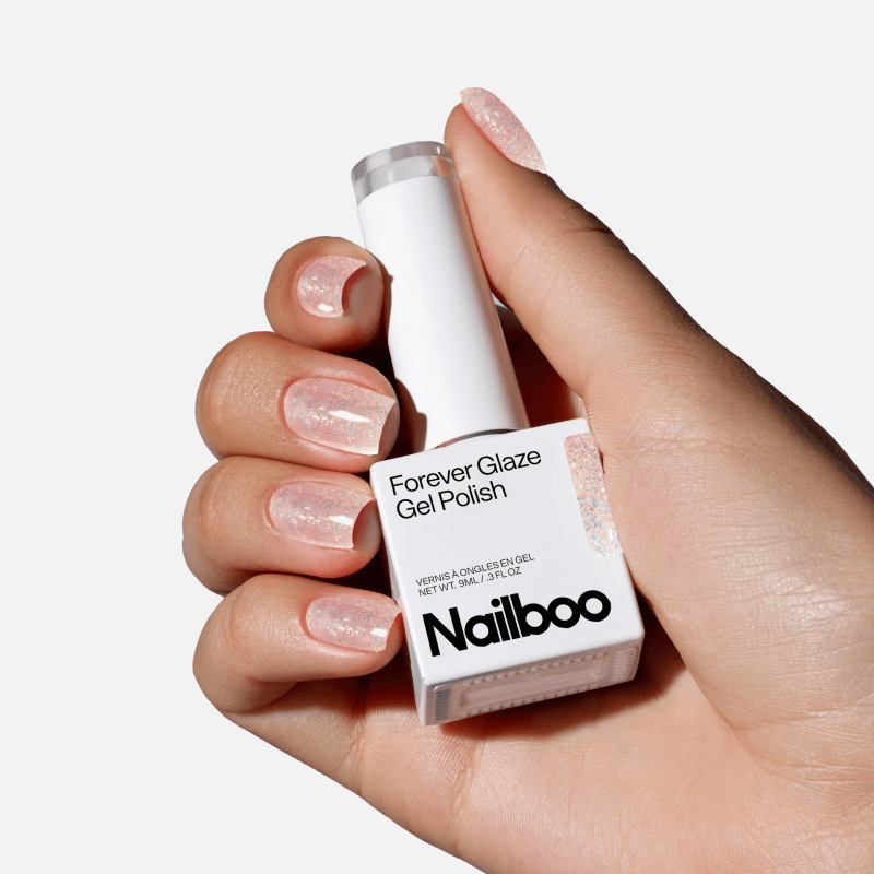 Hand holding a bottle of Nailboo Forever Glaze Gel Polish.