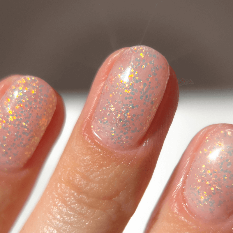 Close-up of fingers with glittery nail polish.
